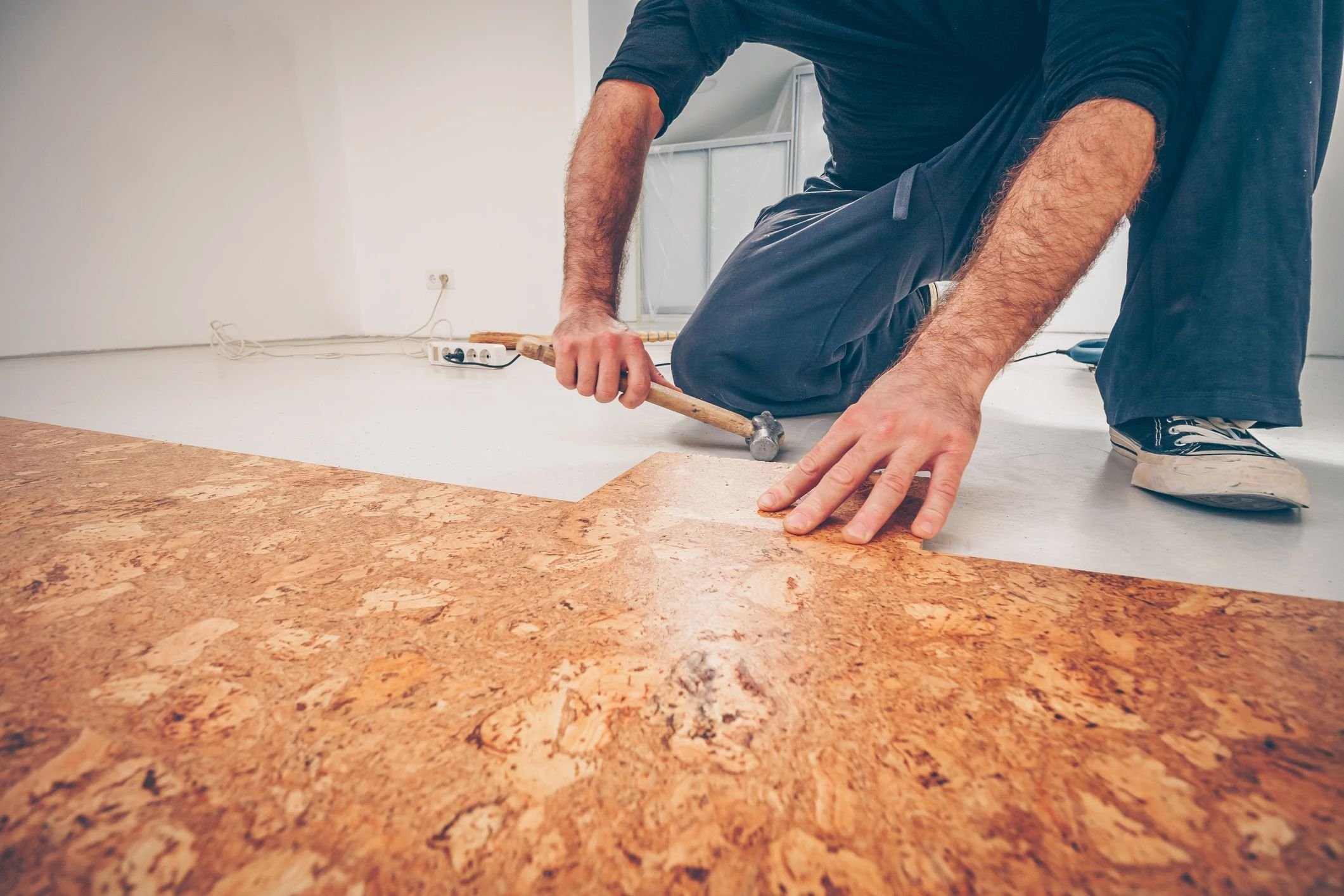 person installing cork floors - Carpet World of Martinsburg in WV